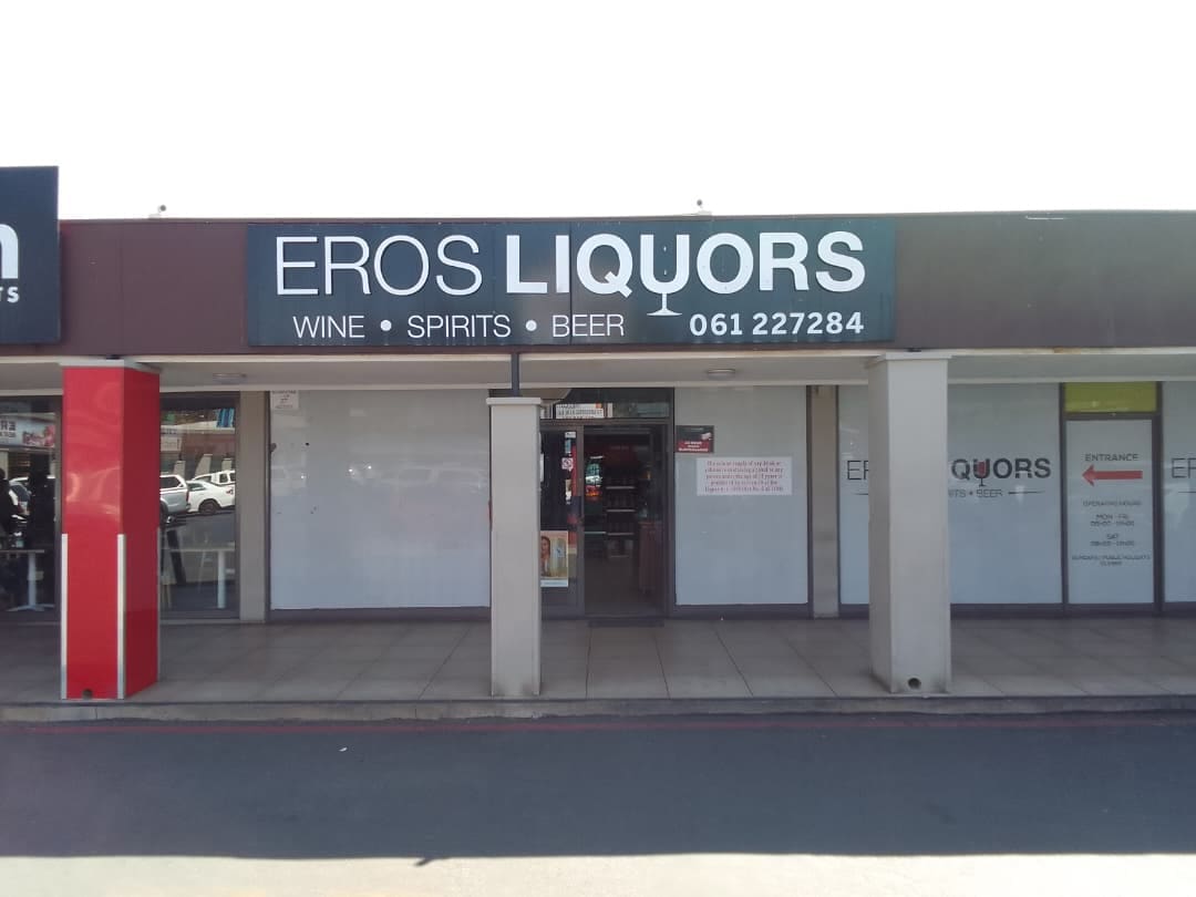 The Eros Liquor Store shopfront — the EROS LIQUORS signboard above the entrance